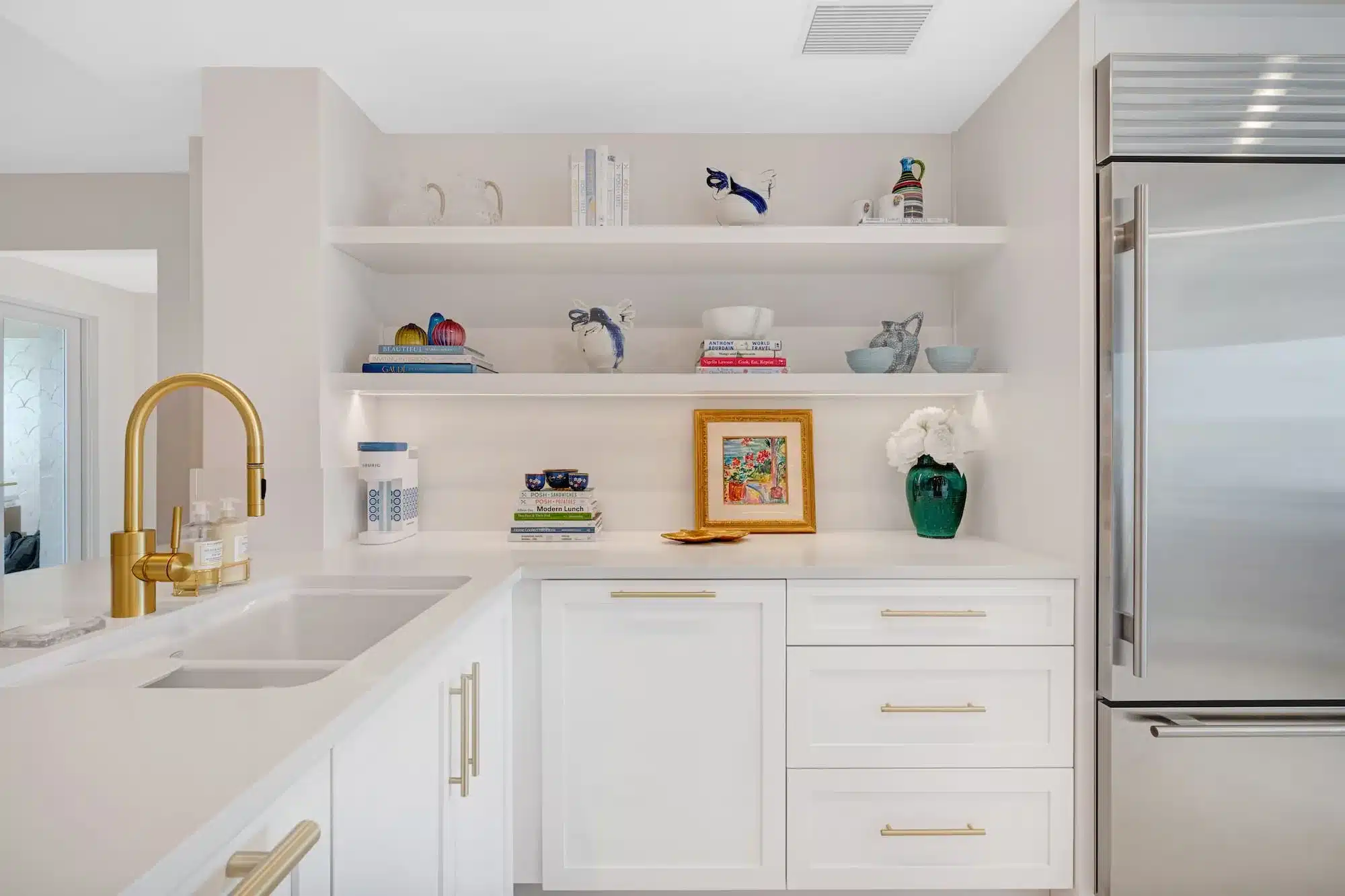 Gold hardware on timeless white cabinets.